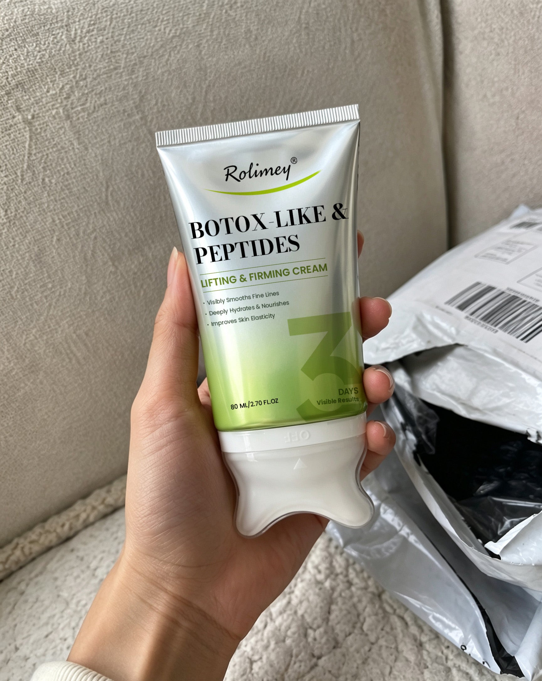 Customer holding Rolimey tube near package